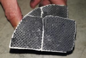 Part of a Diesel Particulate Filter (DPF) showing soot blockage of the honeycomb channels