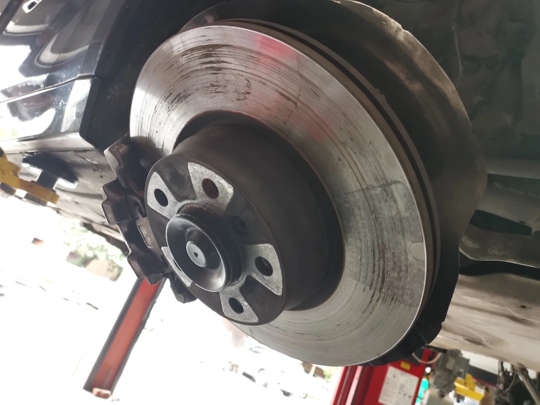 Why Do Brakes Squeak? — BMW 328i brake disc showing damage